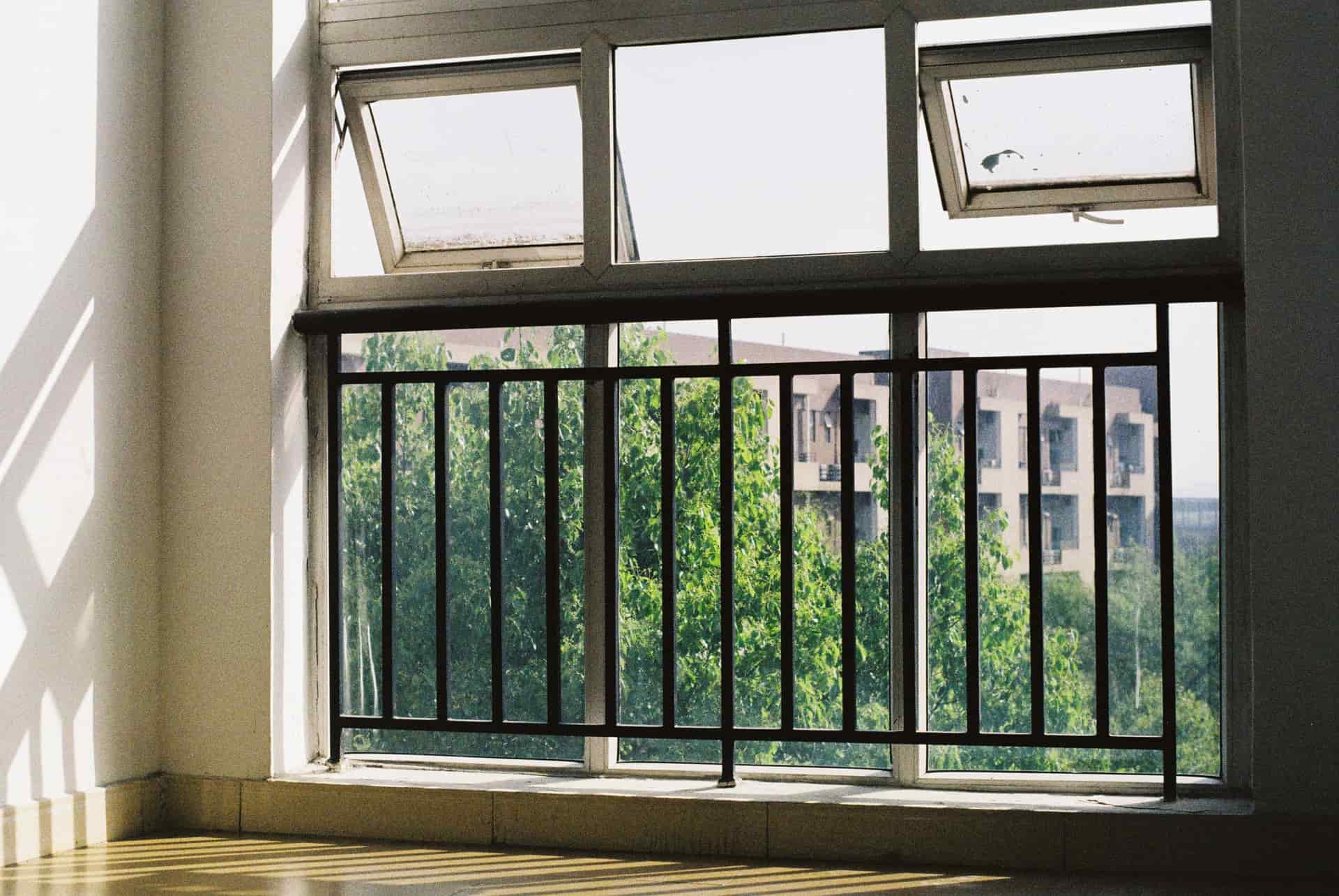 An open apartment window sash on a bright summer day